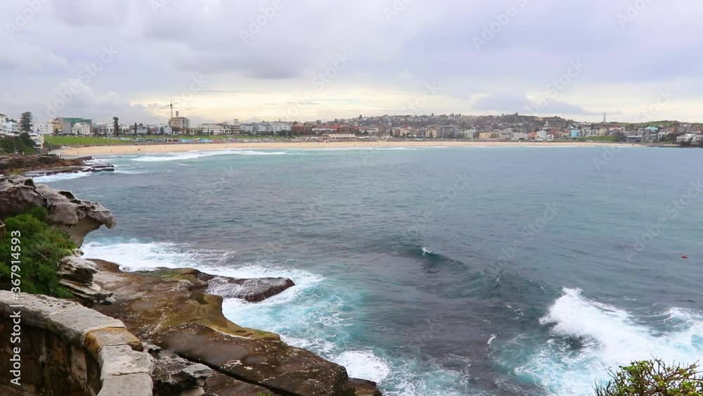 Overlooking Bondi Beach On An Overcast Day At Sunset With Grey Clouds And Blue Water Overlooking Bondi Beach On An Overcast Day At Sunset With Grey Clouds And Blue Water