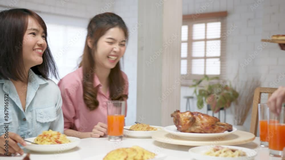 Point of view (POV) happy asian friend eating pizza at home. Group friend cheerful mates laughing enjoying meal having fun sitting together at home dining table, diverse friends share lunch at meeting Point of view (POV) happy asian friend eating pizza at home. Group friend cheerful mates laughing enjoying meal having fun sitting together at home dining table, diverse friends share lunch at meeting