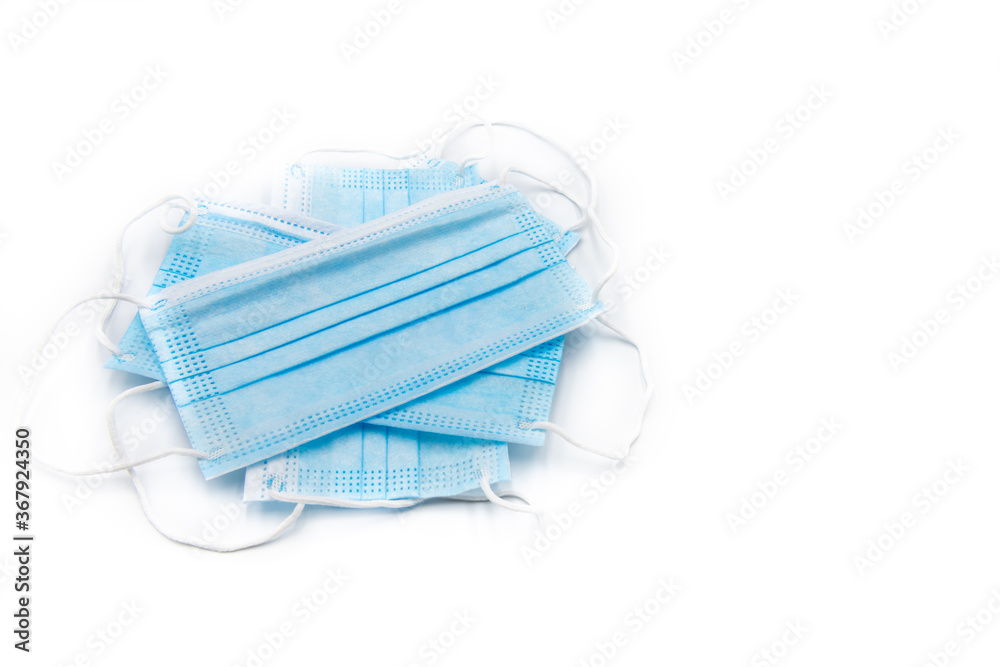 Single use medical face masks isolated over white background, corona virus protection concept Single use medical face masks isolated over white background, corona virus protection concept