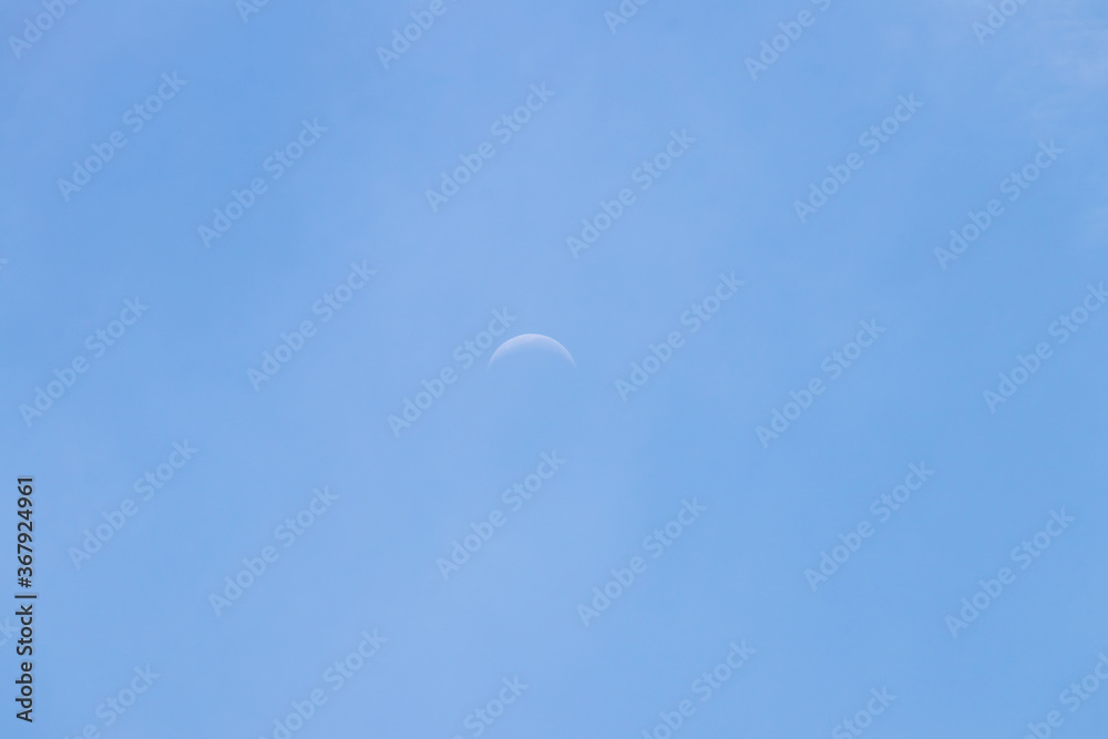 Crescent moon on blue sky. Look like a smile on a good day.
