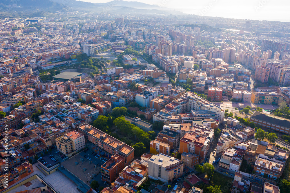 Fototapeta premium Aerial view of Santa Coloma de Gramenet with a apartment buildings and Besos river, Spain