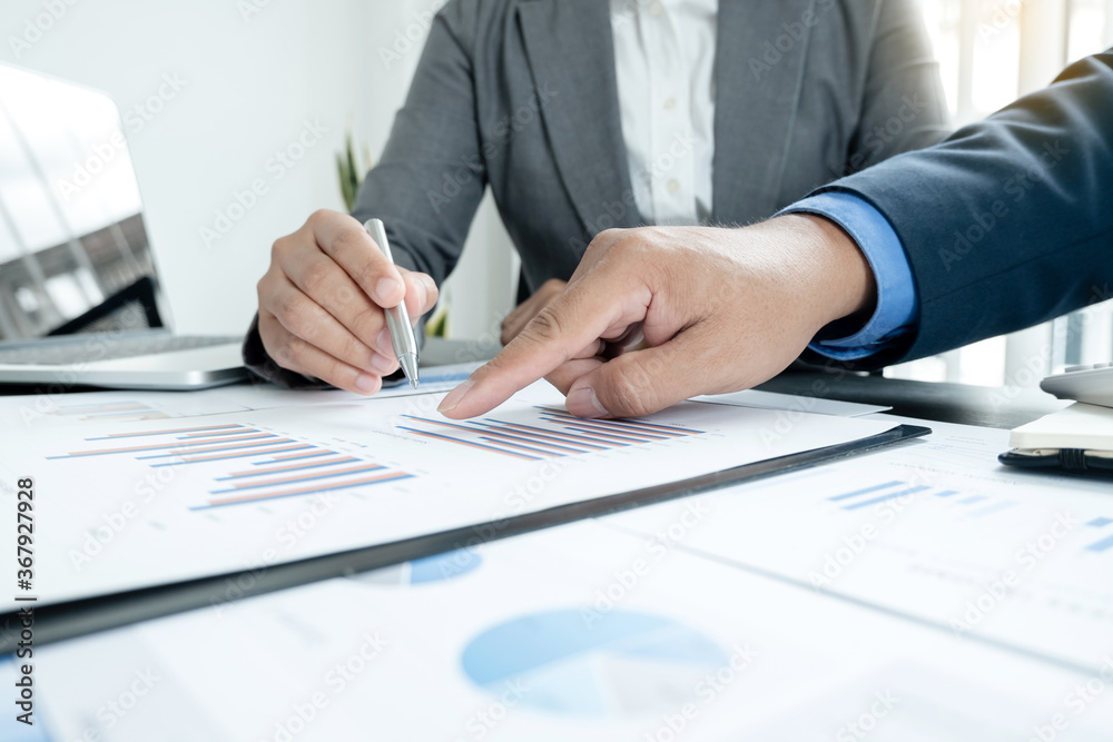 Two business leaders talk about charts, financial graphs showing results are analyzing and calculating planning strategies, business success building processes Two business leaders talk about charts, financial graphs showing results are analyzing and calculating planning strategies, business success building processes