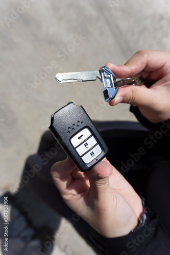 Holding car spare key on close up shot. 