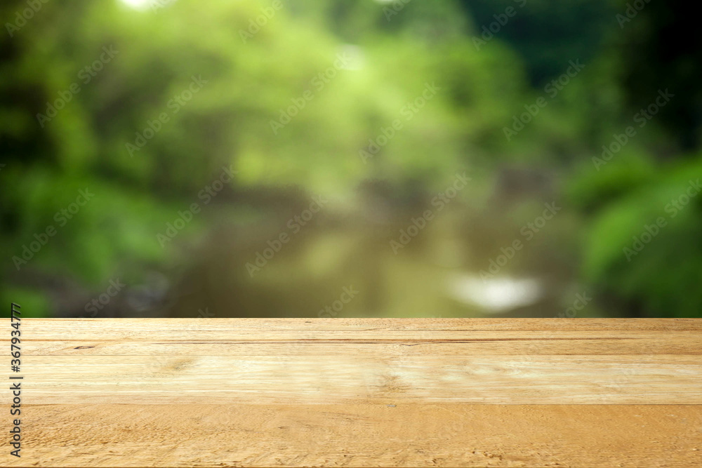 Empty table top on blur green and river background. Empty table top on blur green and river background.