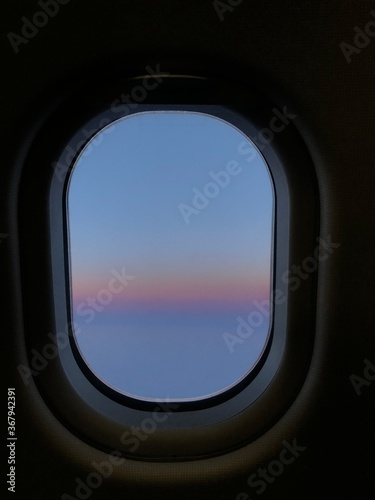 Photo of a sunset taken onboard the business class of commercial flight.