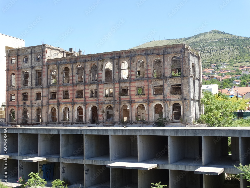 Abandoned house with bullet holes after war in Mostar old city. Mostar is a city and the administrative center of Herzegovina Neretva Canton of the Federation of Bosnia and Herzegovina.