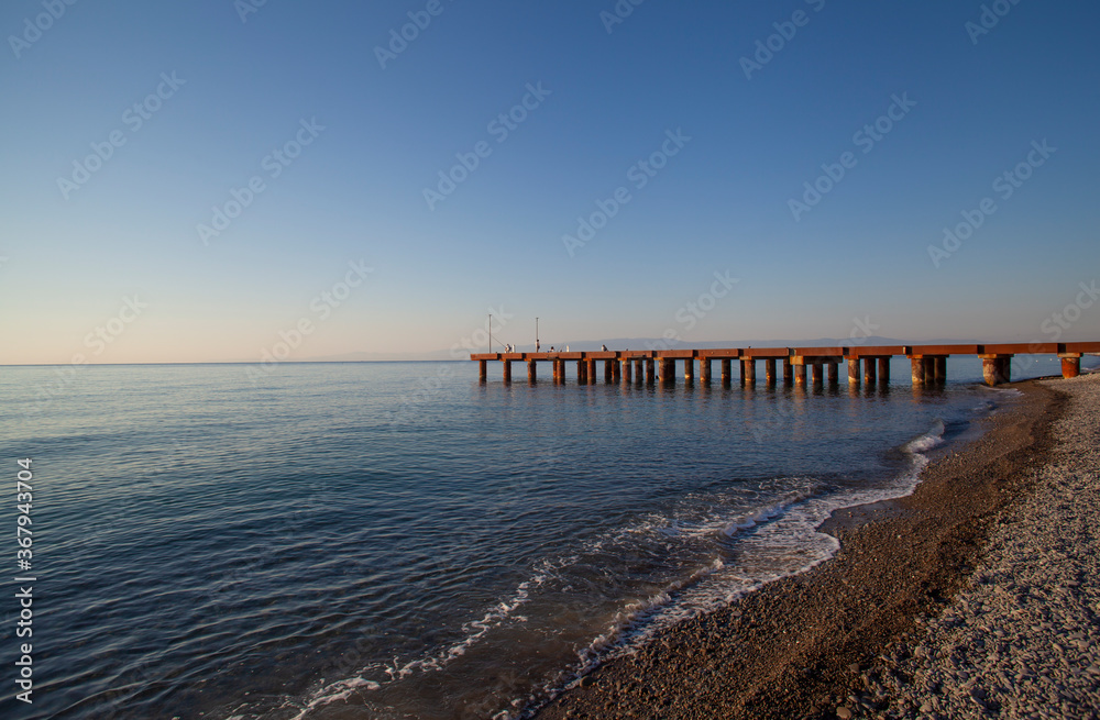 Seascape view with pier in the early morning