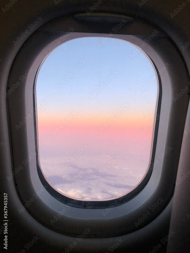 Photo of a sunset taken onboard the business class of commercial flight. Photo of a sunset taken onboard the business class of commercial flight.