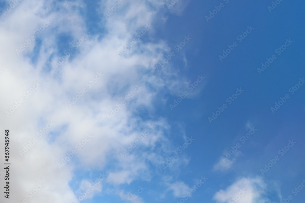 Beautiful Altocumulus clouds on the blue sky during winter sunny day. Theme of beautiful landscapes.	