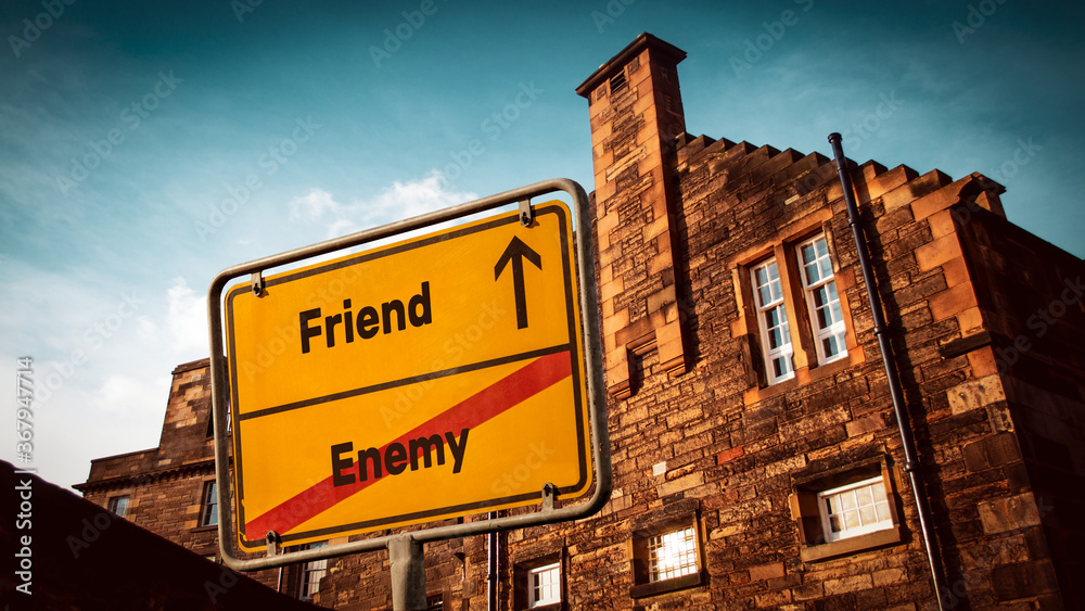 Obraz premium Street Sign to Friend versus Enemy
