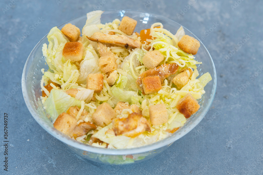 Caesar salad with toast, lettuce and grilled chicken breast and cheese Caesar salad with toast, lettuce and grilled chicken breast and cheese