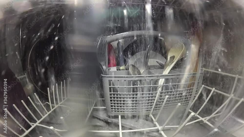 Slow motion. The master repairs the dishwasher and checks the operation