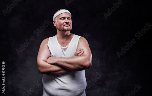 Overweight man in white sportswear with a smile on his face and red cheeks © Fxquadro