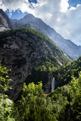 Fantasy landscape of alps mountains stream waterfall at summer hot sunny day
