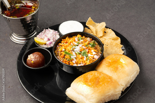 Misal is a meal of curry made from multiple sprouts, spices and served with a common bread.  It is spicy and hot in taste.  photo