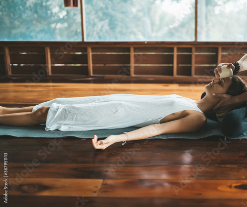 Masseur doing massage female face with rubber ball. photo