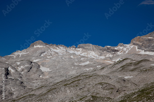 View on snowy alps mountains and ski resort on the middle of summer