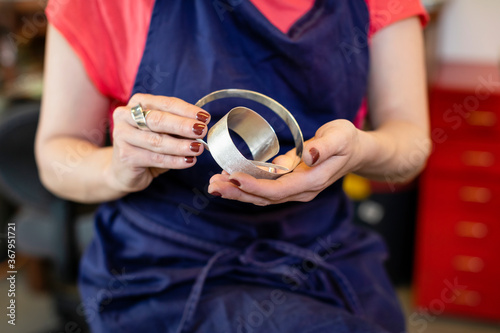 Crop jeweler coiling silver strip photo