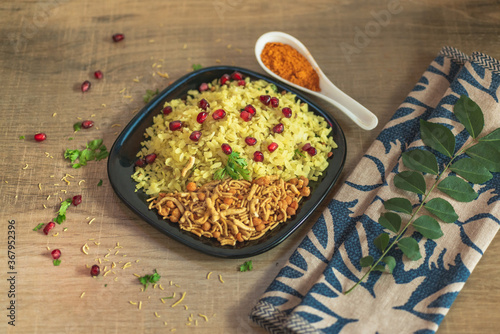 Poha rice flakes breakfast menu. Poha is easy, delicious and healthy breakfast recipe, popular in India. potatoes , onions and seasoning like chilly, lemon and curry leaves, nuts and pomegranate.