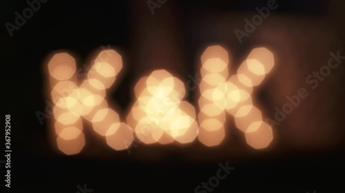 K&K light bulb letter display at wedding event. Camera racks out of focus.  photo