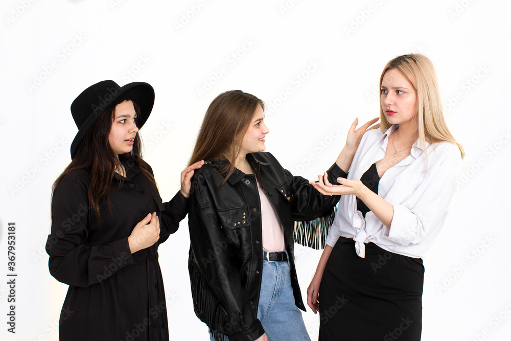 Three girls are discussing something with each other Three girls are discussing something with each other