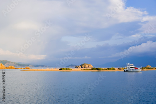 Racing yacht in the sea on blue sky background. Peaceful seascape. Beautiful blue sky over calm sea.