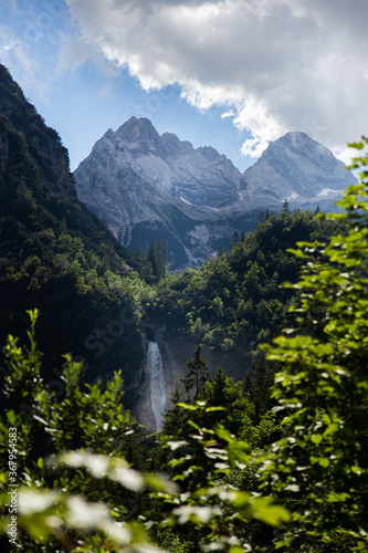Fantasy landscape of alps mountains stream waterfall at summer hot sunny day