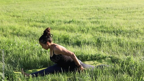 Young girl doing yoga fitness exercise outdoor. Morning sunrise. Meditation and relax