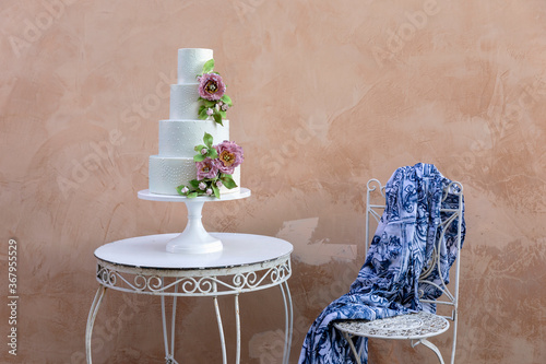 Elegant wedding cake on table photo