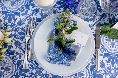 Plate with flower and napkin on banquet table photo