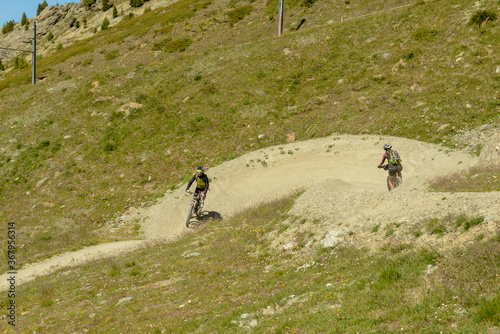 People driving a mtb on a flow trail at Zermatt on the Swiss alps