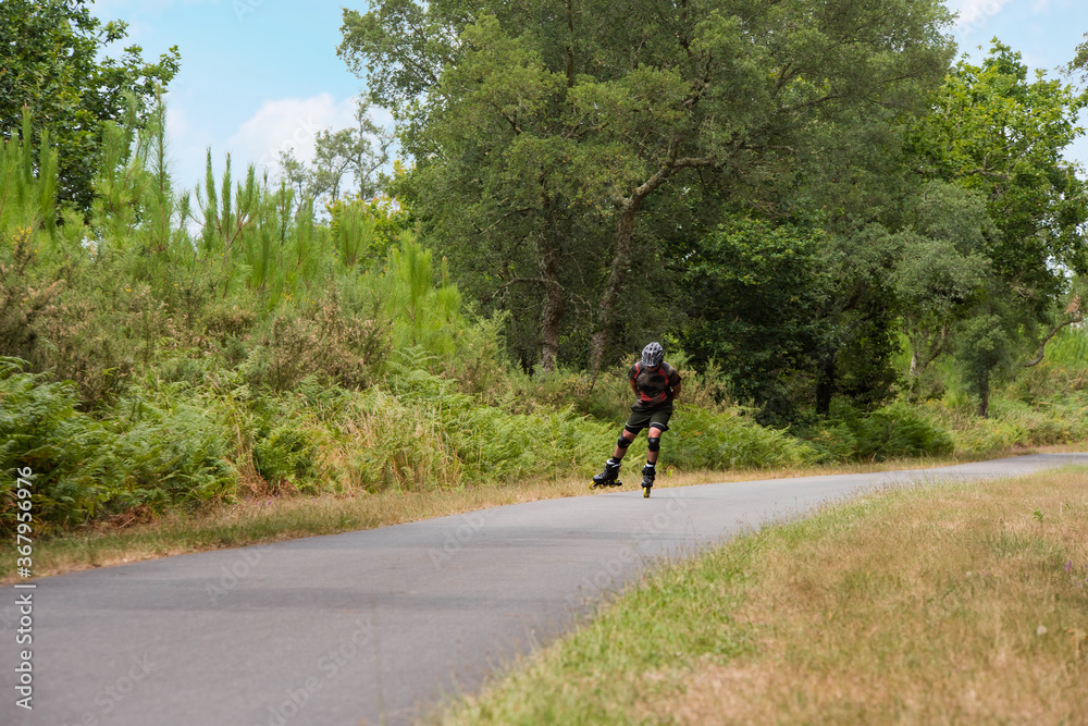 middle aged man rollerblading on the cycle path middle aged man rollerblading on the cycle path