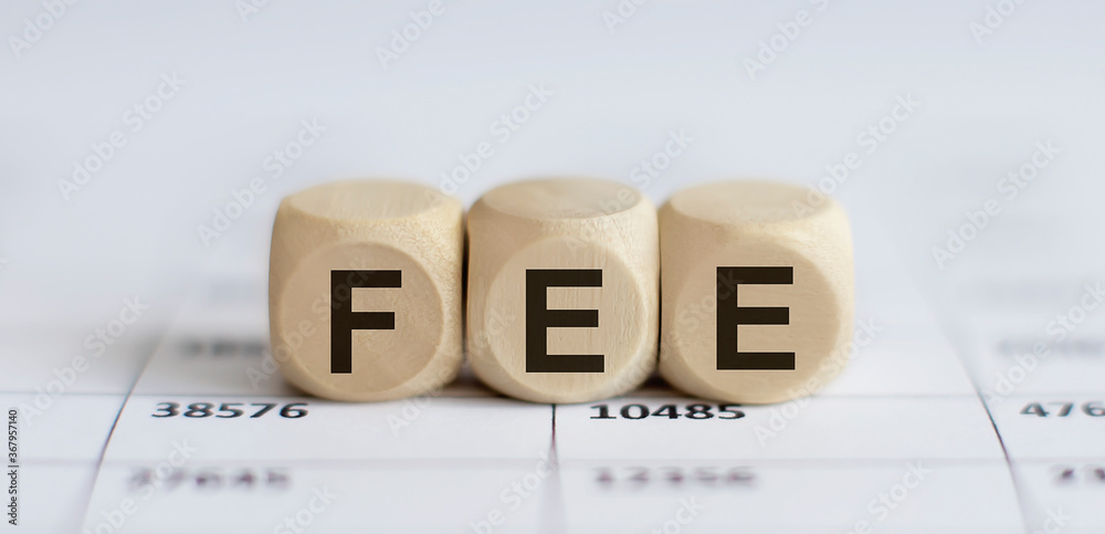 Text FEE on a wooden cube blocks Text FEE on a wooden cube blocks