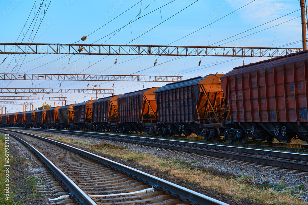 railway and rail cars in a beautiful sunset, dramatic sky and sunlight