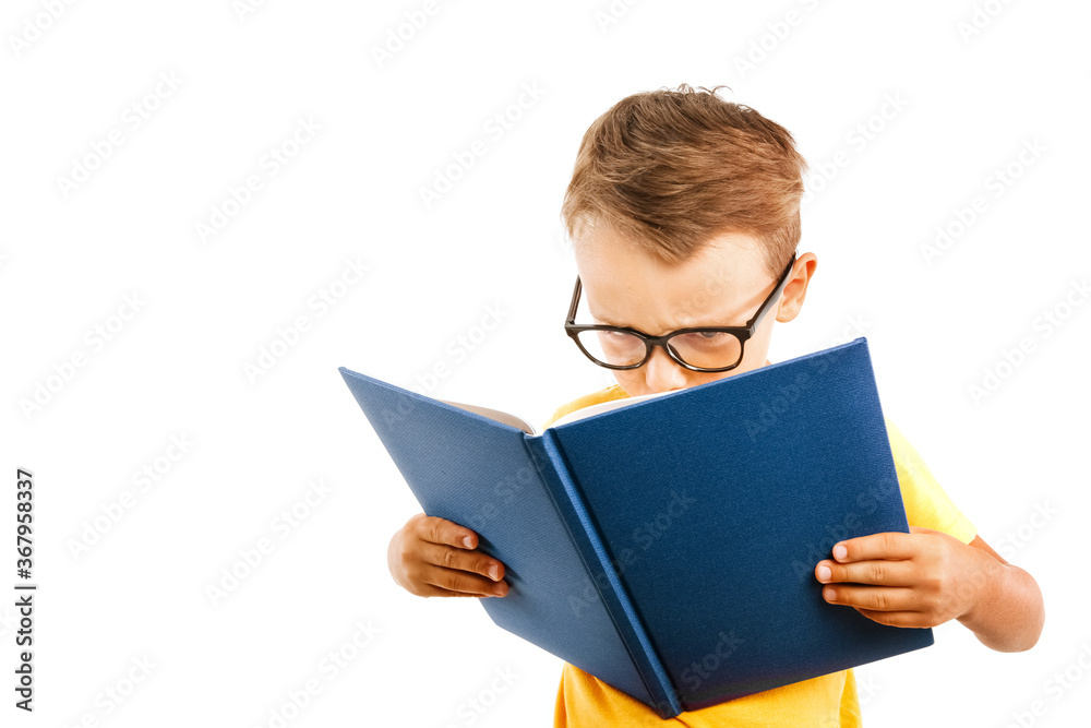 child reads a book against a bright wall child reads a book against a bright wall