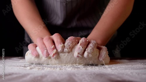 Woman chef prepares the dough for baking bread