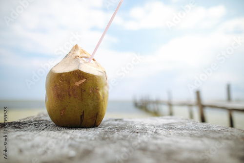 coconut cocktail on wood pier in Caribbean  sea on the beach