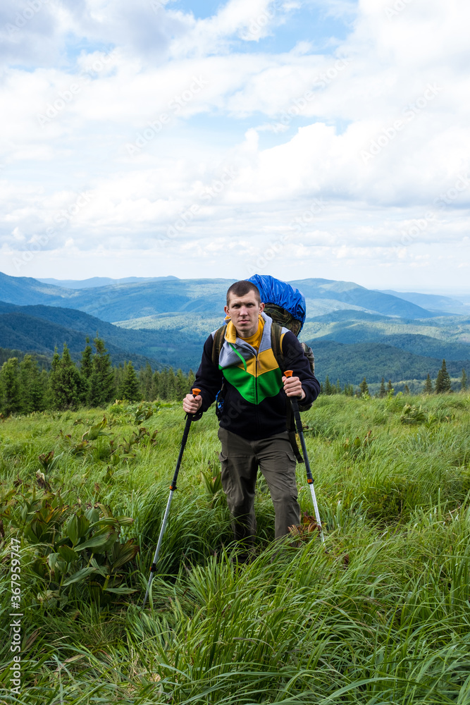 Man hiker in the mountains. Trekking journey and travel concept
