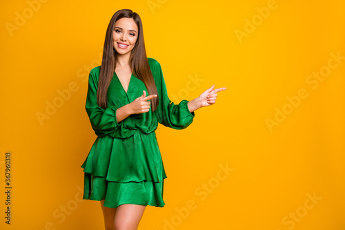 Portrait of her she nice-looking attractive lovely pretty cute winsome cheerful cheery straight-haired girl showing advert ad isolated over bright vivid shine vibrant yellow color background