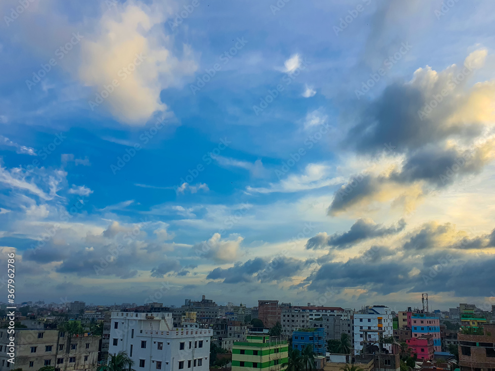 Fototapeta premium Dhaka- city o Bangladesh. Tall buildings and a blue sky full of clouds on a summer afternoon