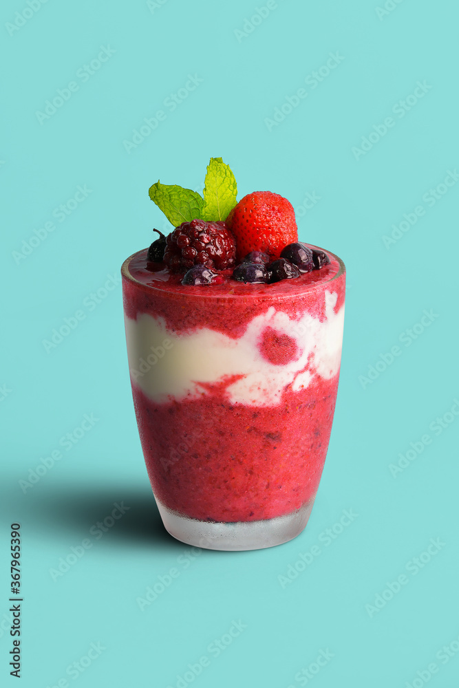 Mixed berry smoothie mixed with yogurt By blending thoroughly in clear glass With berries on top and for those who take care of their shape selective focus at fruits on top Mixed berry smoothie mixed with yogurt By blending thoroughly in clear glass With berries on top and for those who take care of their shape selective focus at fruits on top