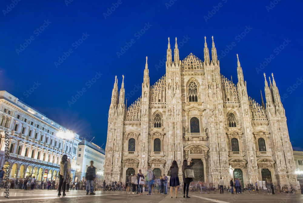 MILAN, ITALY - SEPTEMBER 2015: Tourists and locals enjoy night life in Duomo Square