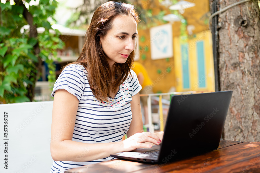 Woman working on laptop from cafe. Busy people lifestyle. Woman working on laptop from cafe. Busy people lifestyle.