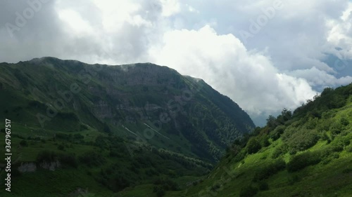 Wallpaper Mural Aerial shot of Alps mountains. Mountains, peaks, cliffs, rocks, ridges, landscape, green grass, sky, clouds, nature, uncultivated nature, drone video. Torontodigital.ca