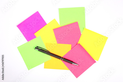 group of blank colorful paper sticky notes and a pen isolated on white background with copy space for your text