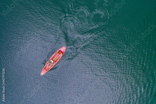 Kayak floats on the river view from the top, from the drone, two guys in the canoe