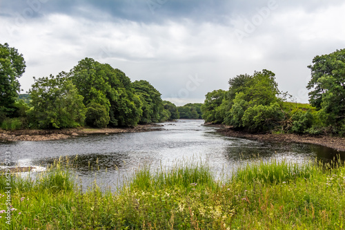 Looking downstream on the River Dee on a cloudy summers day in Galloway  Scotland
