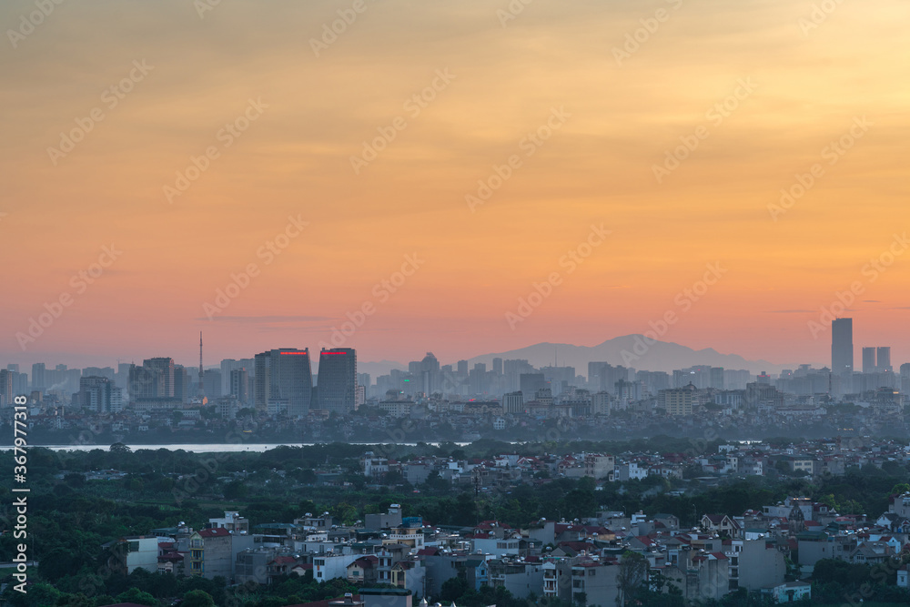 Cityscape of Hanoi skyline at Vinh Tuy bridge over Red river during sunset time