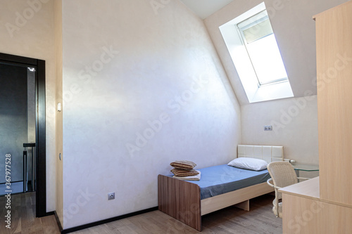 The bedroom in the apartment has a single bed  minimalist design