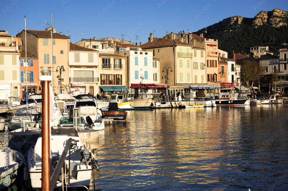 The tranquil harbor of ancient Cassis in France in warm sunlight.